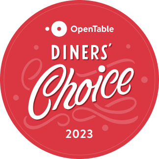 This is a red circular badge for the "OpenTable Diners' Choice 2023" award, featuring artistic white text and a patterned background.